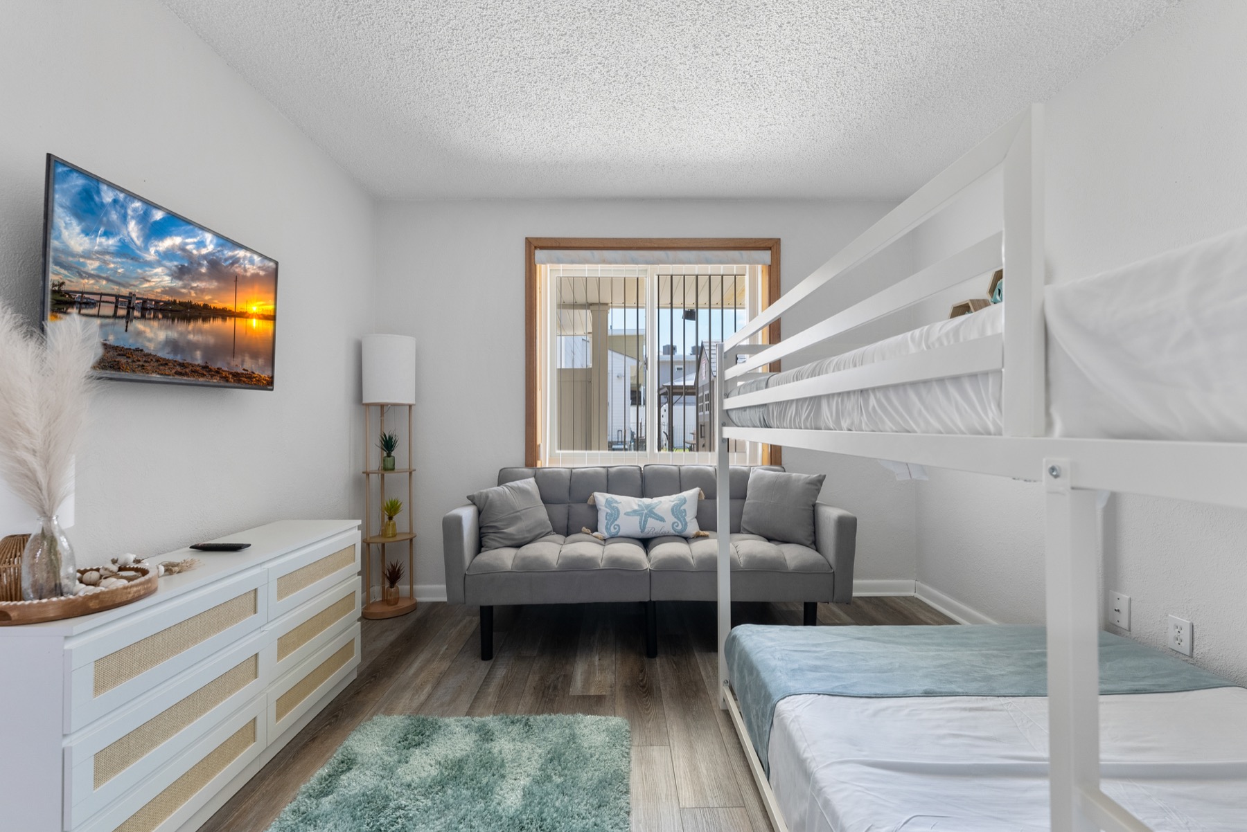 Bedroom with bunk bed, sofa bed, and TV