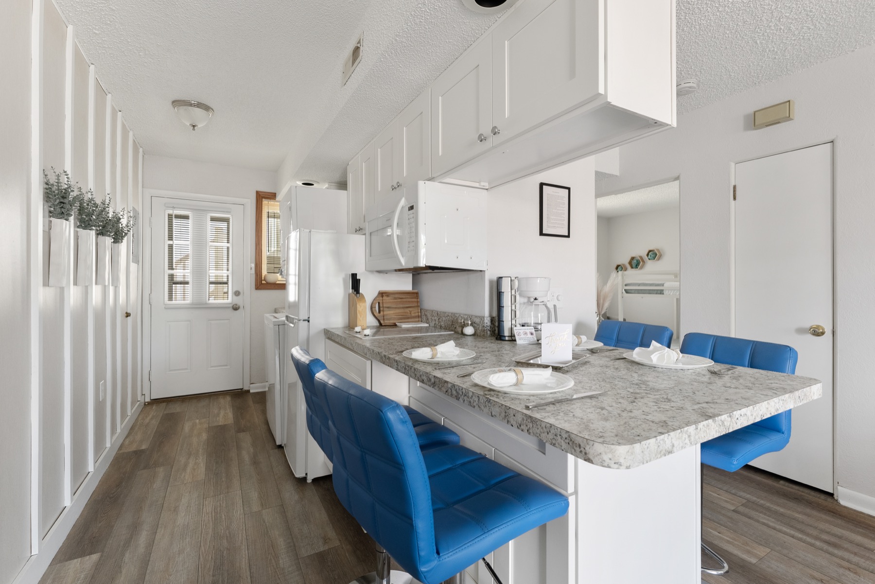 Bright white kitchen with blue counter seating